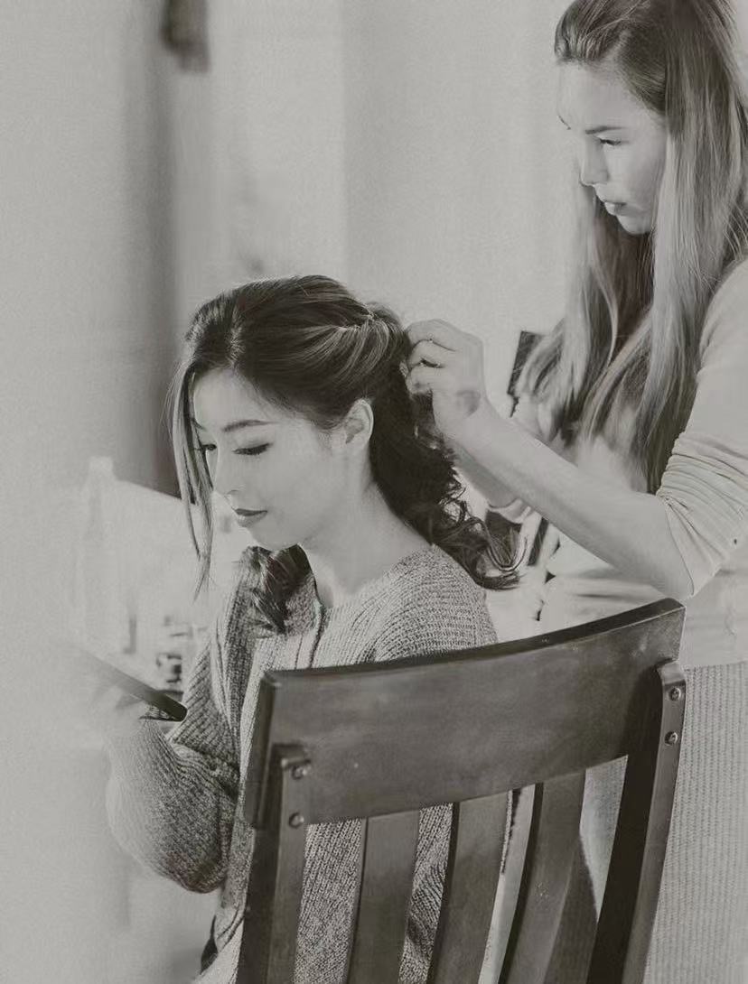 Bride having her hair styled before the ceremony